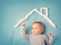 Baby under roof made out of cotton balls 