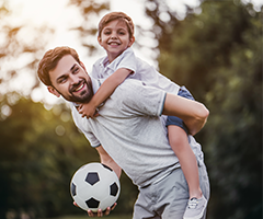 Father and son plaing soccer