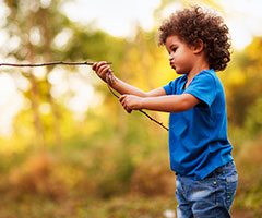 Little boy playing with stick