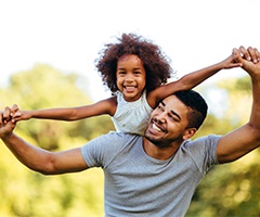 Father and daughter smiling