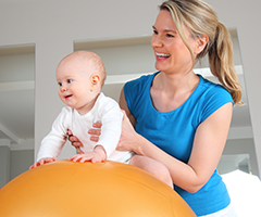 Mother and infant on workout ball