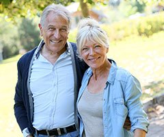 Senior couple hugging outdoors