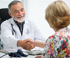 Physician and patient shaking hands