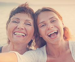 Mother and daughter smiling