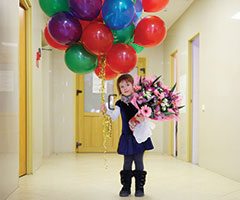 Girl Carrying Balloons from Lee Memorial Gift Shop