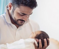 Man holding newborn baby