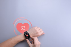 Using a fitness wearable to track one's heart rate. 