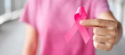 nurse holding pink breast cancer ribbon 