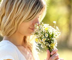 Woman smelling flowers