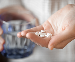 Person holding pills