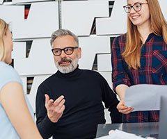 Man and two women talking