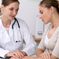 Physician comforting cervical cancer patient