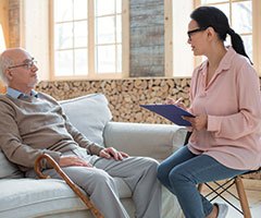 Senior sitting across young woman