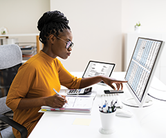 Woman looking at spreadsheet on computer