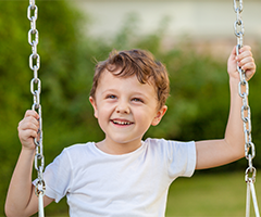 Little boy on swing set