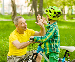 Man with little boy on bike