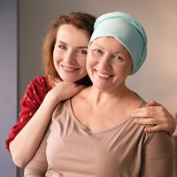 Woman hugging cancer patient
