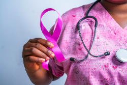 nurse holding a purple cancer ribbon