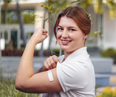 Woman flexing arm after vaccination