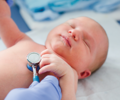 Stethoscope on newborns chest