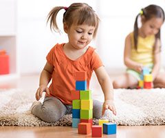 Toddler playing with colorful blocks