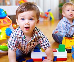 Toddler crawling with toys