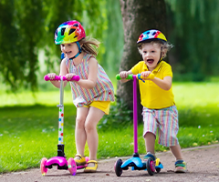 Children riding colorful scooters