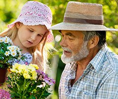 Child and senior picking flowers