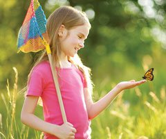 Little girl catching butterflies