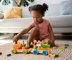 Toddler playing with toy train