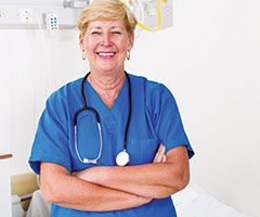 Nurse smiling in patient room