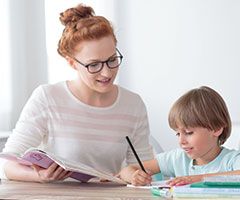 Woman and child doing schoolwork
