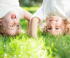 two children doing handstands