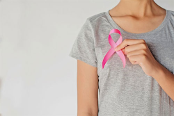 women holding pink breast cancer ribbon 