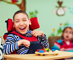 Disabled child laughing and smiling