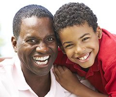 Father and son smiling