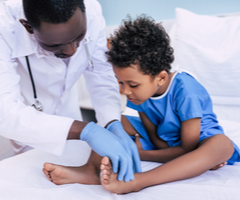 Physician treating pediatric patient