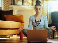 Women Sitting at Home Meditating 