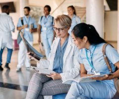 Two women looking at clipboard