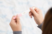 Woman holding pregnancy test