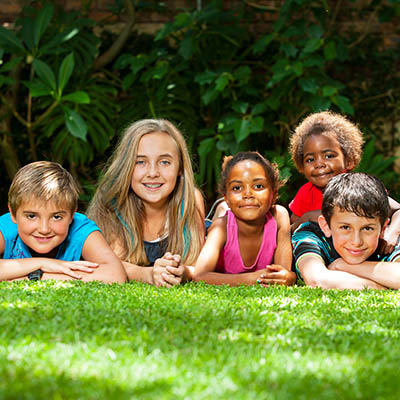 Children laying in grass