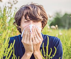 Person blowing nose