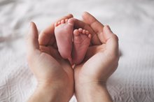 Baby feet in hands