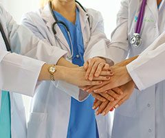 Physicians holding hands