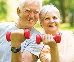 Man and woman lifting weights
