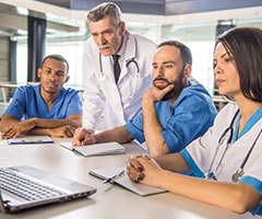 Healthcare team looking at laptop