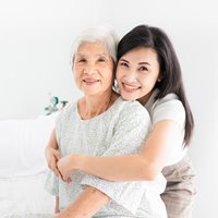 Woman hugging senior woman