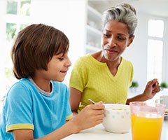 Mother and son eating breakfast