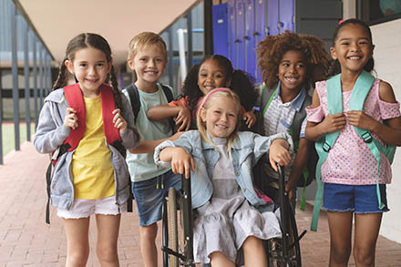 child in wheelchair with friends