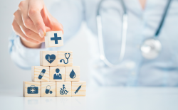 Physician putting together healthcare building blocks